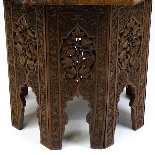 1429 - An early / mid 20thC Moorish table of unusually large proportions and walnut construction, with an o... 