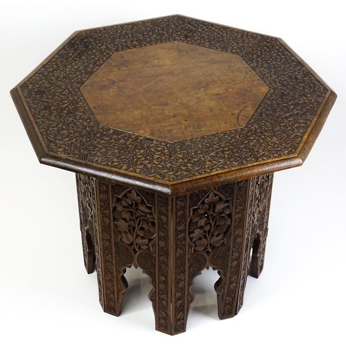 1429 - An early / mid 20thC Moorish table of unusually large proportions and walnut construction, with an o... 