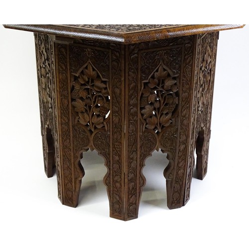 1429 - An early / mid 20thC Moorish table of unusually large proportions and walnut construction, with an o... 