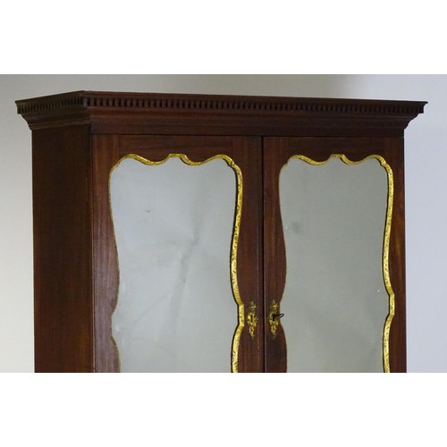 1431 - A George II mahogany bureau bookcase with a moulded cornice above two mirrored doors opening to show... 