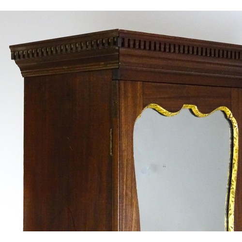 1431 - A George II mahogany bureau bookcase with a moulded cornice above two mirrored doors opening to show... 