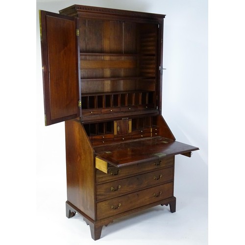 1431 - A George II mahogany bureau bookcase with a moulded cornice above two mirrored doors opening to show... 