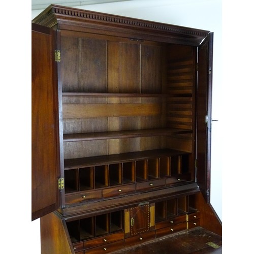 1431 - A George II mahogany bureau bookcase with a moulded cornice above two mirrored doors opening to show... 
