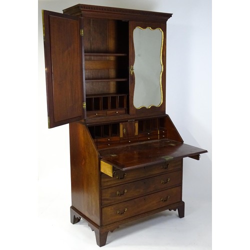 1431 - A George II mahogany bureau bookcase with a moulded cornice above two mirrored doors opening to show... 