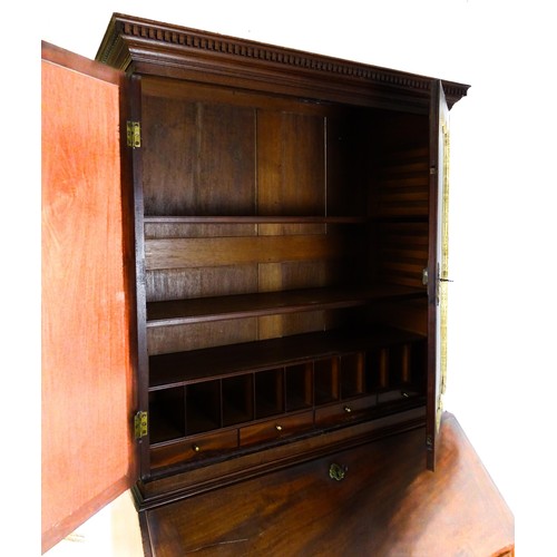 1431 - A George II mahogany bureau bookcase with a moulded cornice above two mirrored doors opening to show... 