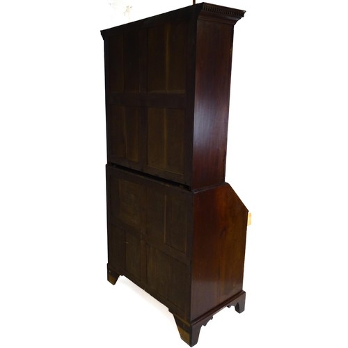 1431 - A George II mahogany bureau bookcase with a moulded cornice above two mirrored doors opening to show... 