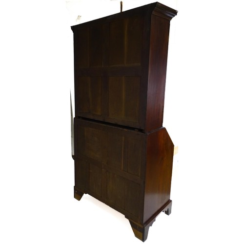 1431 - A George II mahogany bureau bookcase with a moulded cornice above two mirrored doors opening to show... 