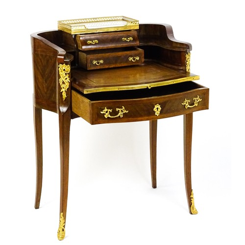1469 - An early 20thC kingwood and rosewood Bonheur du jour surmounted by a marble panel and pierced gilt s... 