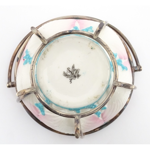 95 - A Belleek sugar bowl with pink scallop shell and blue painted detail, with a silver plate lid and st... 