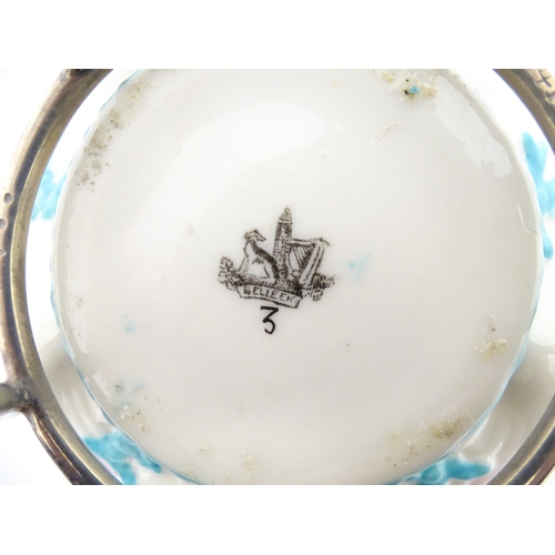 95 - A Belleek sugar bowl with pink scallop shell and blue painted detail, with a silver plate lid and st... 