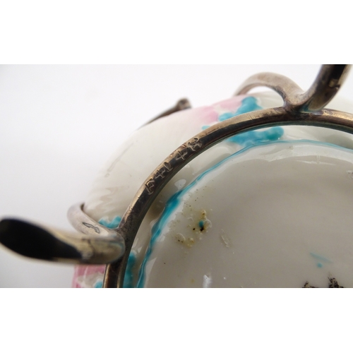 95 - A Belleek sugar bowl with pink scallop shell and blue painted detail, with a silver plate lid and st... 