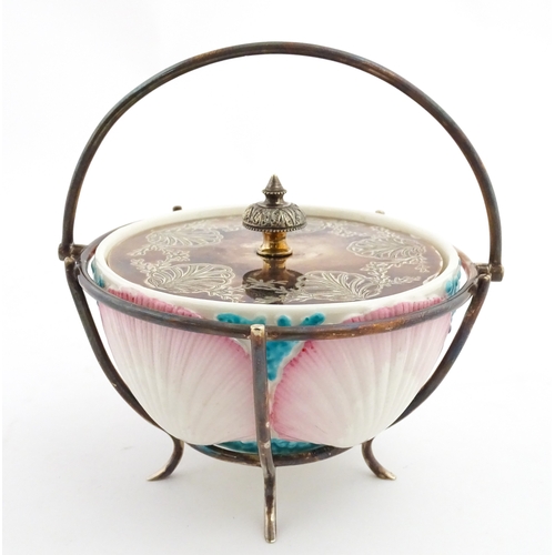 95 - A Belleek sugar bowl with pink scallop shell and blue painted detail, with a silver plate lid and st... 