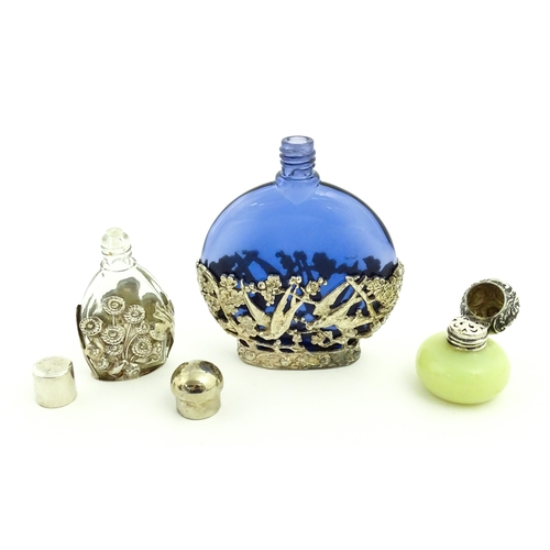 229 - Two glass scent / perfume bottles one with silver mounts / cover  hallmarked London 1990 together wi... 