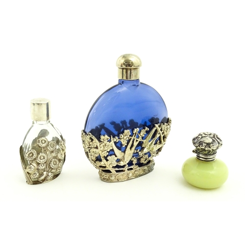 229 - Two glass scent / perfume bottles one with silver mounts / cover  hallmarked London 1990 together wi... 