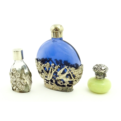 229 - Two glass scent / perfume bottles one with silver mounts / cover  hallmarked London 1990 together wi... 