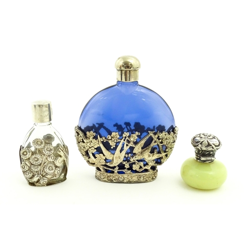 229 - Two glass scent / perfume bottles one with silver mounts / cover  hallmarked London 1990 together wi... 