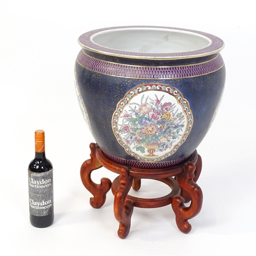 30 - A Chinese jardiniere decorated with panels depicting flowers and foliage, the interior decorated wit... 