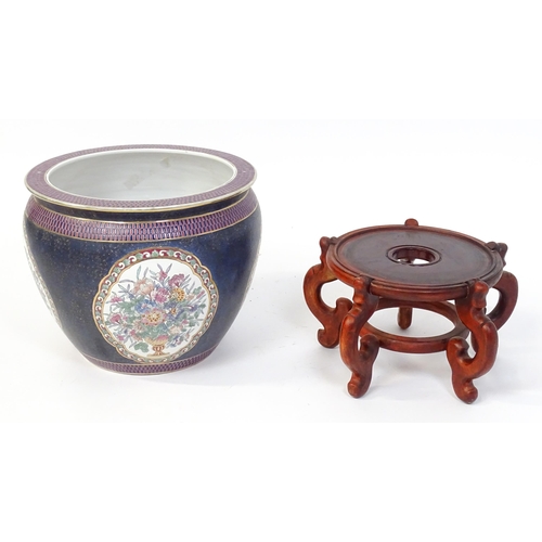 30 - A Chinese jardiniere decorated with panels depicting flowers and foliage, the interior decorated wit... 