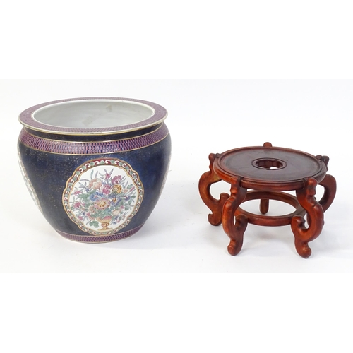 30 - A Chinese jardiniere decorated with panels depicting flowers and foliage, the interior decorated wit... 