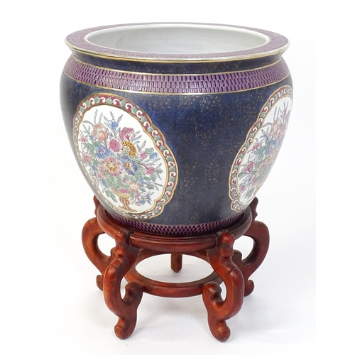 30 - A Chinese jardiniere decorated with panels depicting flowers and foliage, the interior decorated wit... 