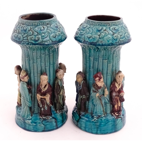 61 - A pair of Chinese vases with bamboo detail and decorated with the 7 immortals in relief. Approx. 10 ... 