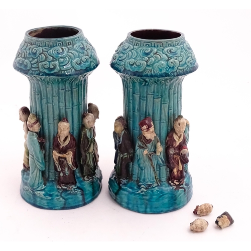 61 - A pair of Chinese vases with bamboo detail and decorated with the 7 immortals in relief. Approx. 10 ... 