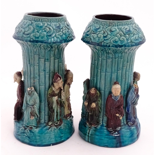 61 - A pair of Chinese vases with bamboo detail and decorated with the 7 immortals in relief. Approx. 10 ... 