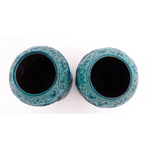 61 - A pair of Chinese vases with bamboo detail and decorated with the 7 immortals in relief. Approx. 10 ... 