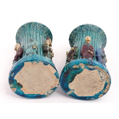 61 - A pair of Chinese vases with bamboo detail and decorated with the 7 immortals in relief. Approx. 10 ... 