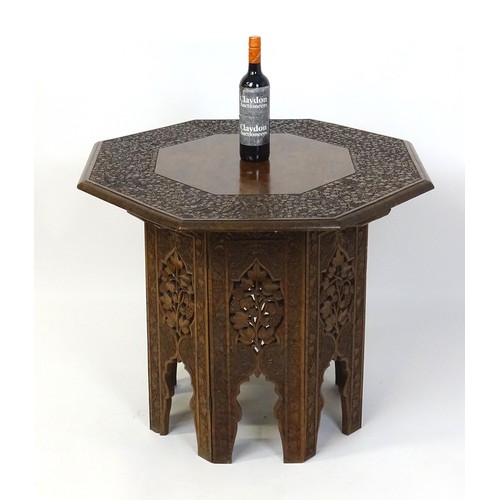 1429 - An early / mid 20thC Moorish table of unusually large proportions and walnut construction, with an o... 