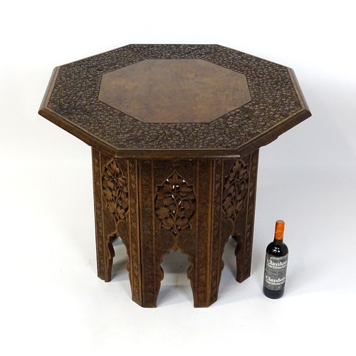 1429 - An early / mid 20thC Moorish table of unusually large proportions and walnut construction, with an o... 