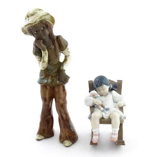 182 - A Lladro model Nap Time, model no. 5448. Together with a ceramic model of a girl. Largest approx. 10... 