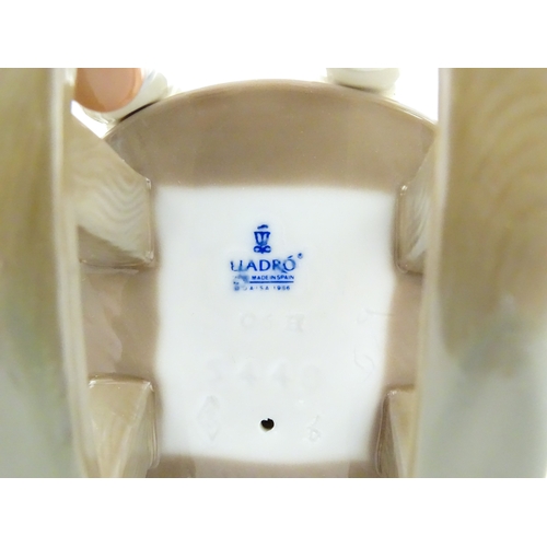 182 - A Lladro model Nap Time, model no. 5448. Together with a ceramic model of a girl. Largest approx. 10... 