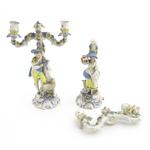 189 - A pair of Continental figural twin branch candlesticks modelled as shepherd and shepherdess, each wi... 