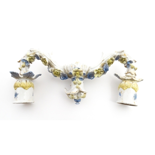 189 - A pair of Continental figural twin branch candlesticks modelled as shepherd and shepherdess, each wi... 