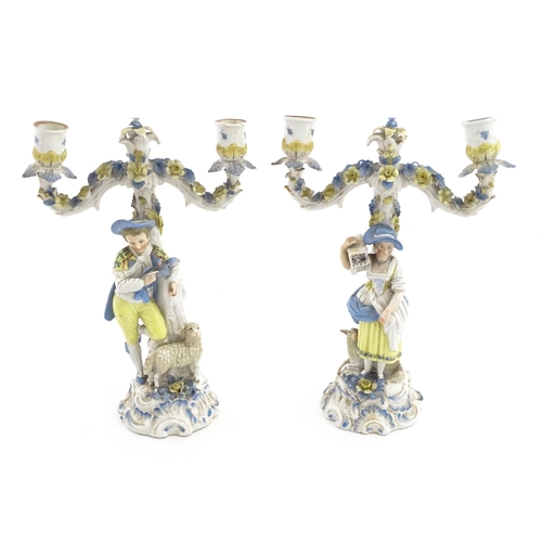 189 - A pair of Continental figural twin branch candlesticks modelled as shepherd and shepherdess, each wi... 