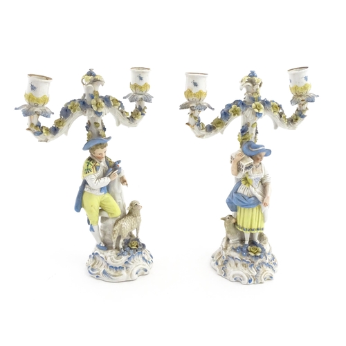 189 - A pair of Continental figural twin branch candlesticks modelled as shepherd and shepherdess, each wi... 