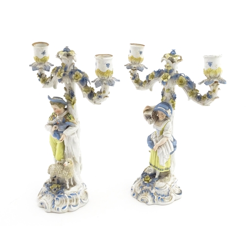 189 - A pair of Continental figural twin branch candlesticks modelled as shepherd and shepherdess, each wi... 