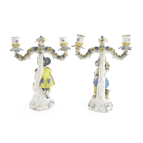 189 - A pair of Continental figural twin branch candlesticks modelled as shepherd and shepherdess, each wi... 