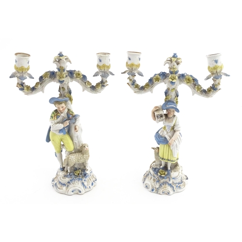 189 - A pair of Continental figural twin branch candlesticks modelled as shepherd and shepherdess, each wi... 