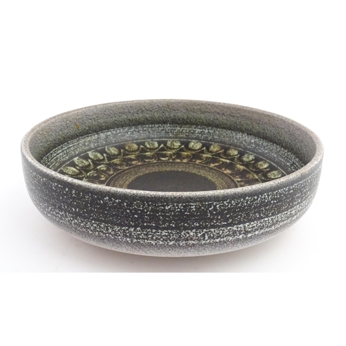 195 - A large Spanish studio pottery bowl with banded decoration, signed Serra. Approx. 12