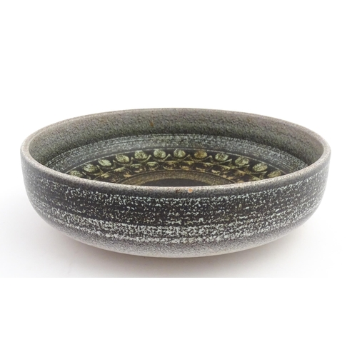 195 - A large Spanish studio pottery bowl with banded decoration, signed Serra. Approx. 12