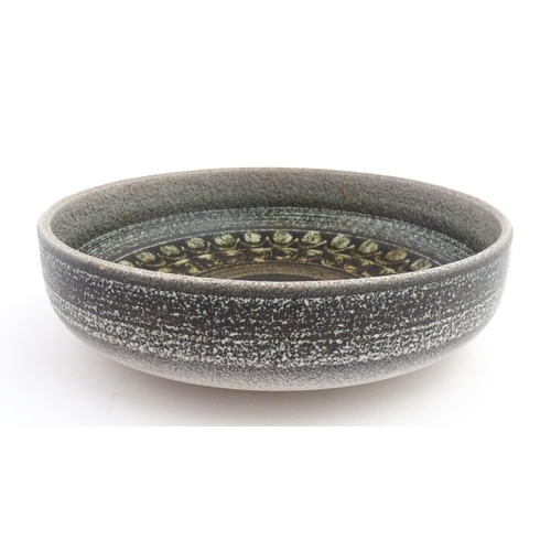 195 - A large Spanish studio pottery bowl with banded decoration, signed Serra. Approx. 12