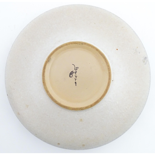 195 - A large Spanish studio pottery bowl with banded decoration, signed Serra. Approx. 12