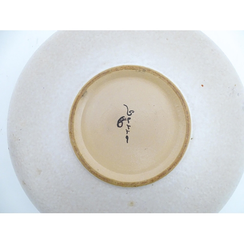 195 - A large Spanish studio pottery bowl with banded decoration, signed Serra. Approx. 12