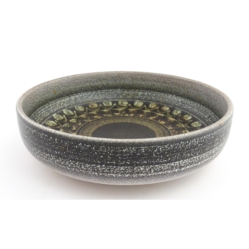 195 - A large Spanish studio pottery bowl with banded decoration, signed Serra. Approx. 12