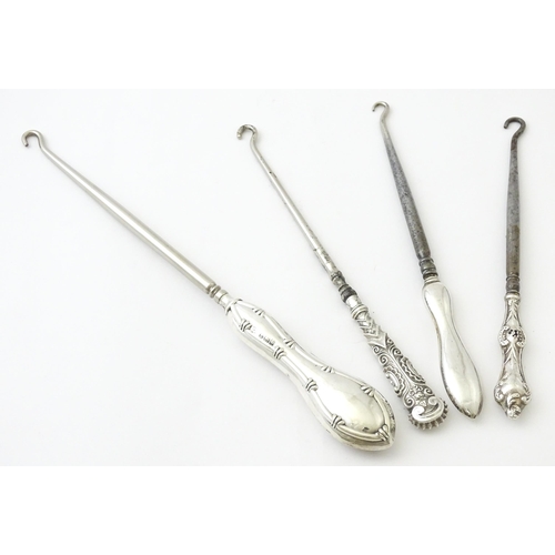 494 - Four various silver handled button hooks. To include examples hallmarked Birmingham 1898 maker Adie ... 