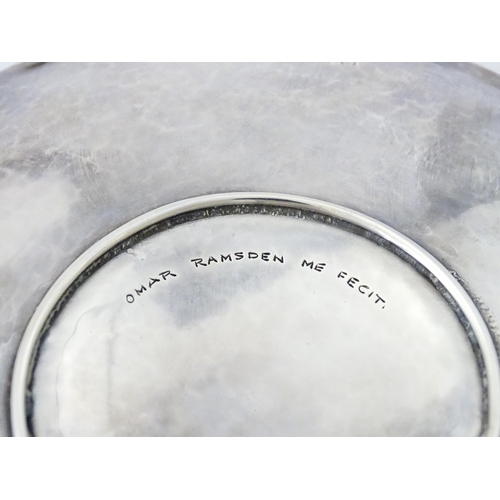 501 - An Arts & Crafts silver dish of circular form with hammered decoration and centre Tudor rose motif, ... 