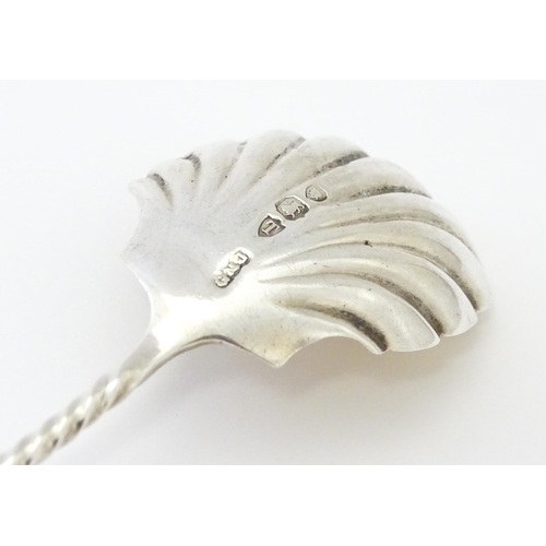 513 - A Victorian silver sugar spoon with shell formed bowl and openwork detail, hallmarked London 1894, m... 
