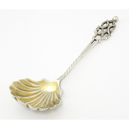 513 - A Victorian silver sugar spoon with shell formed bowl and openwork detail, hallmarked London 1894, m... 